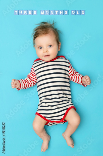 Portrait of adorable 3 months old baby on the blue background, studio shot