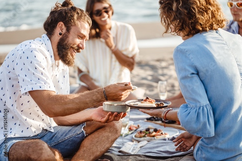 People Enjoying Food on Beach Picnic