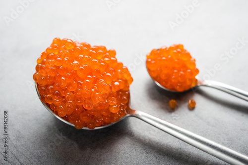 Closeup of spoon with red caviar on a background. appetizer seafood
