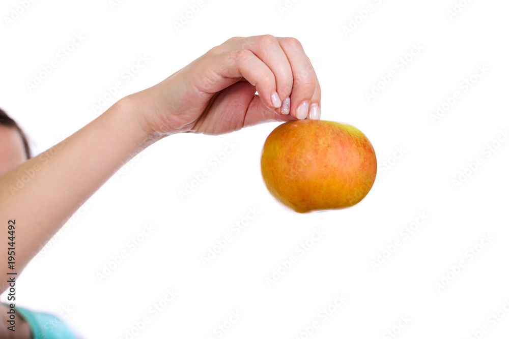 One hand extended forward holds apple One hand extended forward holds apple
