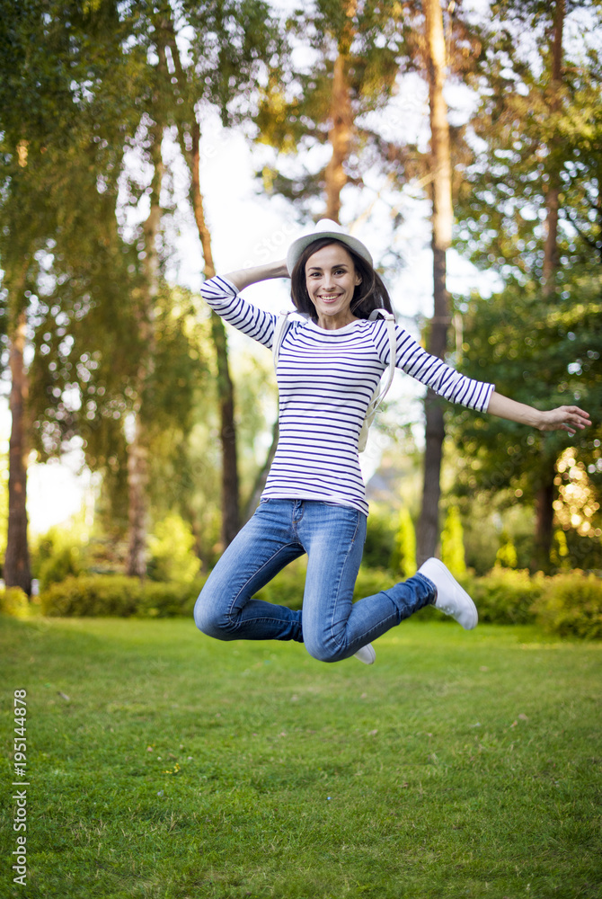 Weekend is coming soon. Happy young woman in everyday clothes and hat jumping up with joy. Weekend is coming soon. Happy young woman in everyday clothes and hat jumping up with joy.