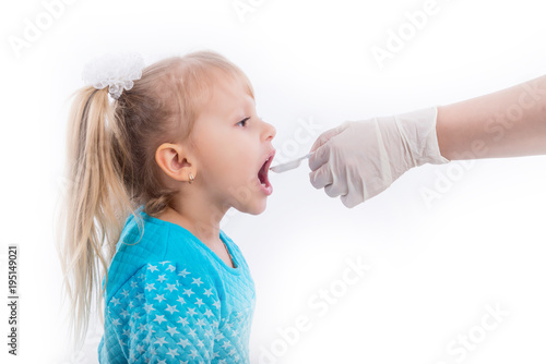 Doctor hand giving spoon dose of medicine liquid drinking syrup to child