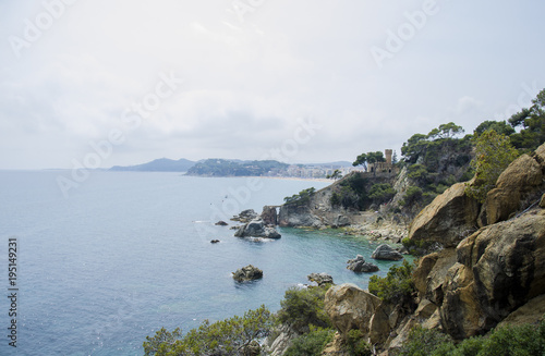 Panoramic view of Lloret de Mar Castle at sunset, Costa Brava between Barcelona and Girona, Spain. Ancient Fortress in Lloret de Mar, Spain. Castle Sant Joan in Costa Brava , Lloret De Mar, Catalonia. photo