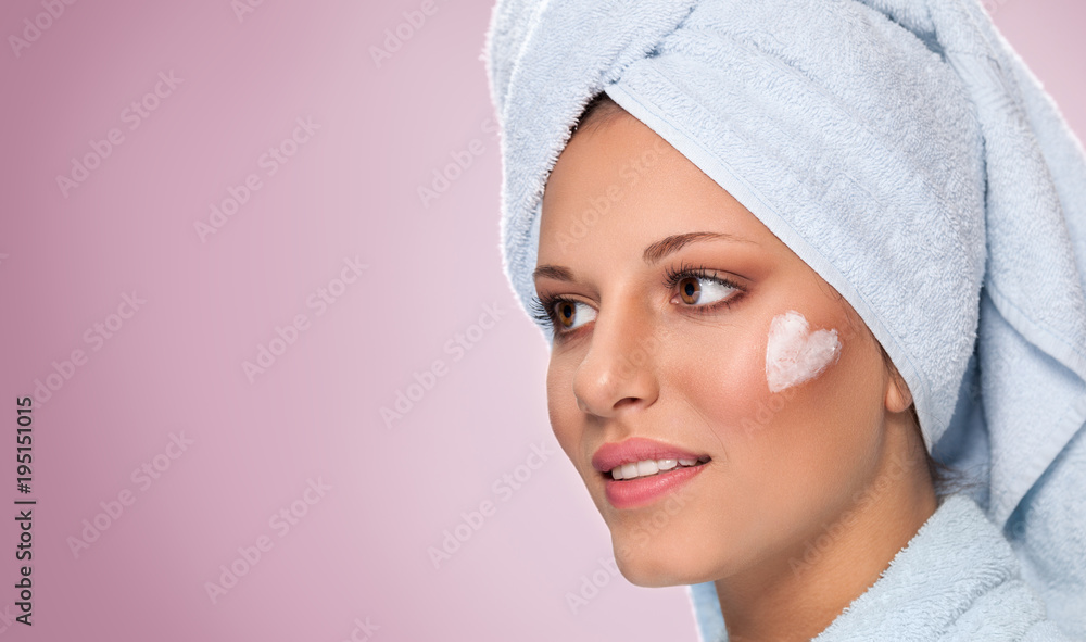 Young woman with moisturizing cream on her face, healthy skin concept. Young woman with moisturizing cream on her face, healthy skin concept.