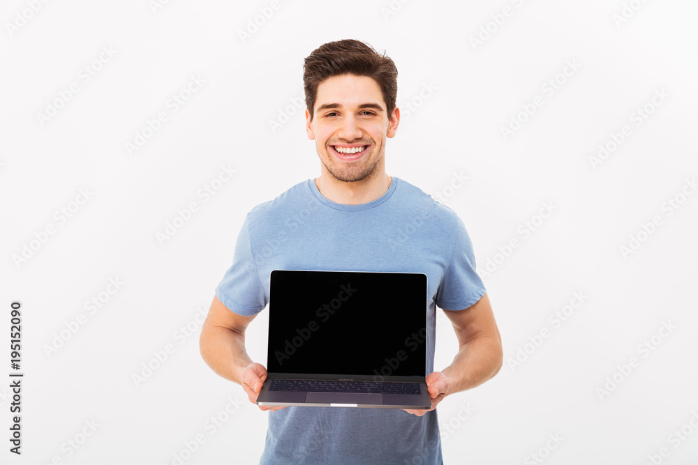 Image of happy smiling man with bristle holding silver notebook demonstrating or advertising copyspace screen, isolated over white background Image of happy smiling man with bristle holding silver notebook demonstrating or advertising copyspace screen, isolated over white background