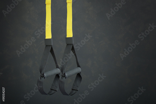 Trx training loop equipment. Black trx loop functional training equipment on grey background. Sport accessories. Fitness and Gym workout items for Healthy.