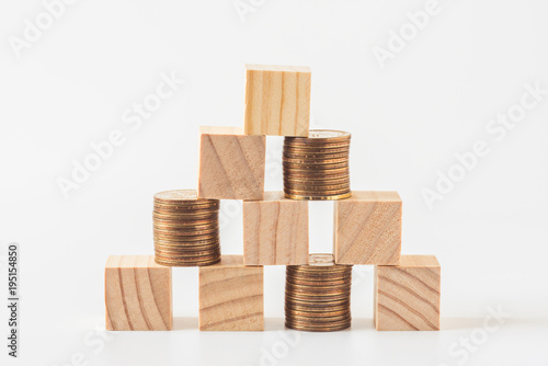 stack of wood cube building blocks and money coins