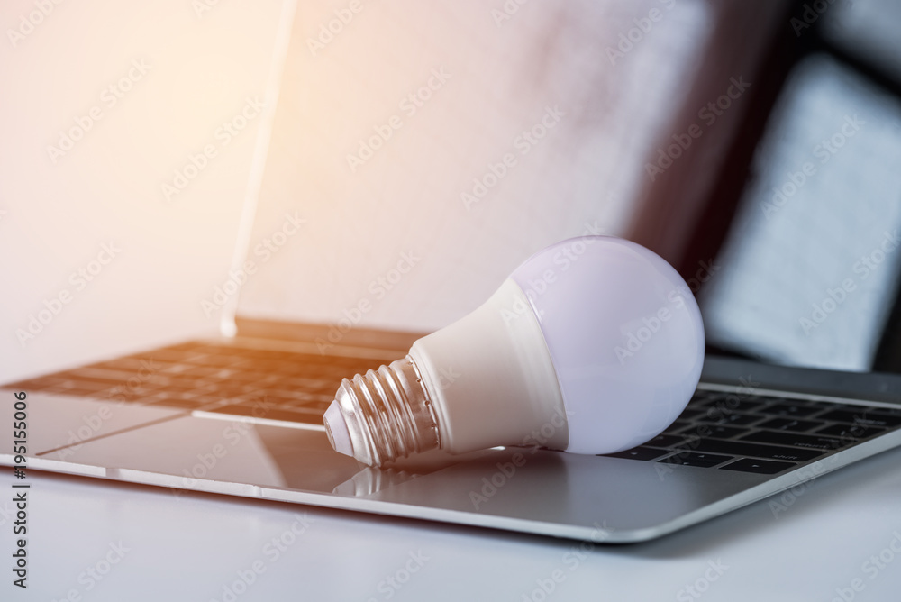 light bulb on laptop computer background light bulb on laptop computer background