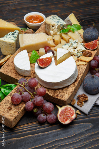 Various types of cheese - parmesan, brie, roquefort, cheddar