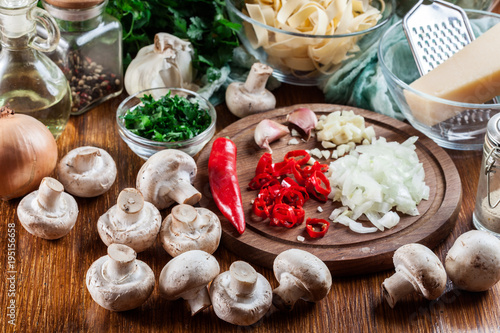 Ingredients ready for prepare tagliatelle pasta with champignon