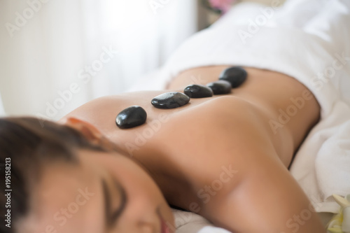 Beautiful woman spa hot stone massage beauty Treatments.