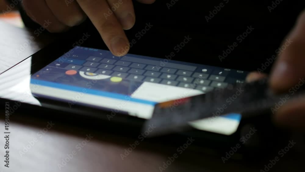 Shopping online with credit card on digital tablet pc. Closeup. Online banking with smartphone. Shopping online with credit card on digital tablet pc. Closeup. Online banking with smartphone.