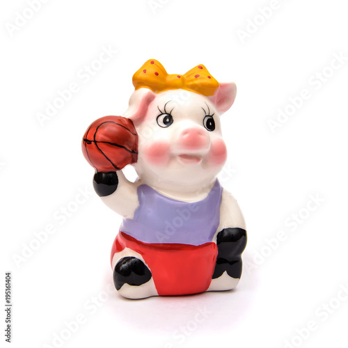Porcelain figure of a pig with the ball  isolate