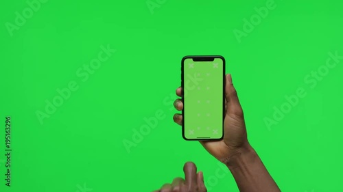 Female Hand holding Green Screen Smartphone and Scrolling Up