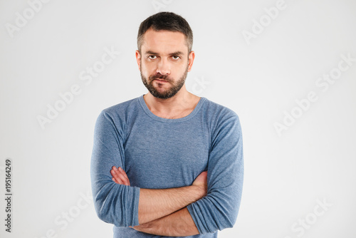 Angry displeased man standing isolated