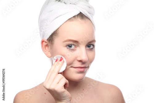 Beautiful young woman in towel after shower on white background