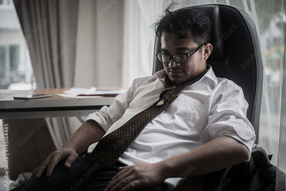 Worried business man at workplace in office after tired from hard work. Fail business concept.