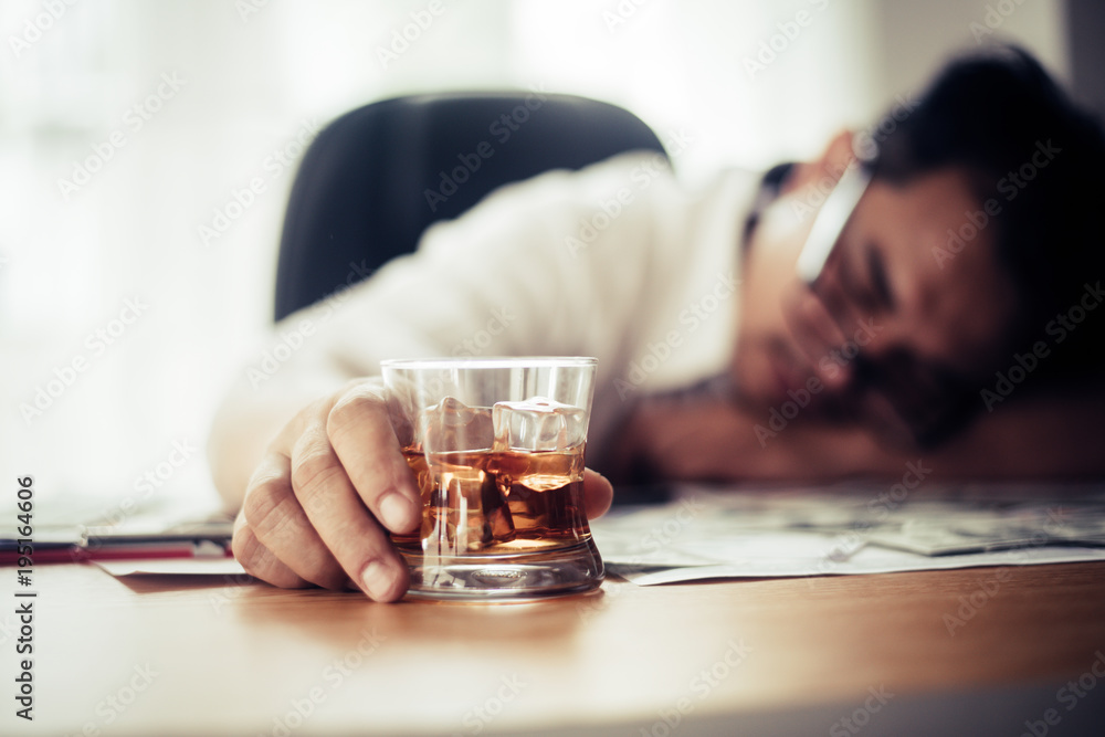 Businessman drinking from stress at workplace Businessman drinking from stress at workplace