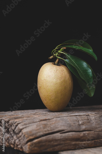 Sapodilla fruits on the old wood