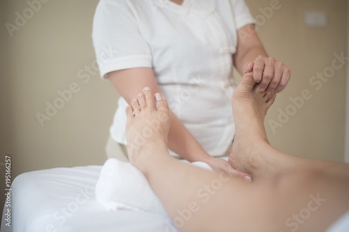 Beautiful woman having feet massage in beauty salon, relax and healthy.