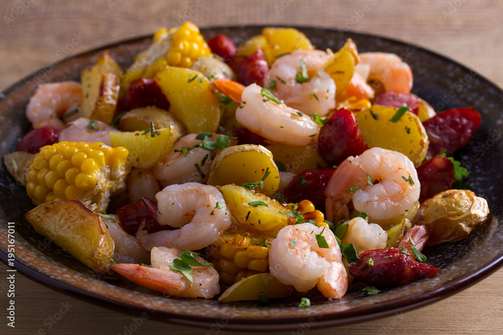 Shrimps with sausages, new potatoes and sweet corn. One sheet pan shrimps with sausages and vegetables Shrimps with sausages, new potatoes and sweet corn. One sheet pan shrimps with sausages and vegetables