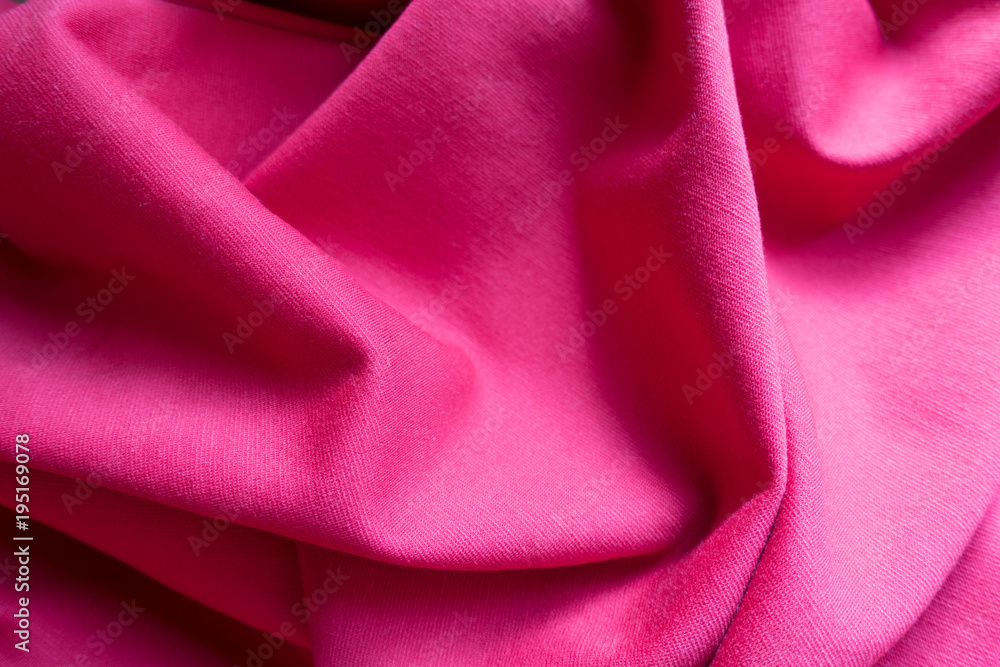 Simple pink jersey fabric in soft folds Simple pink jersey fabric in soft folds