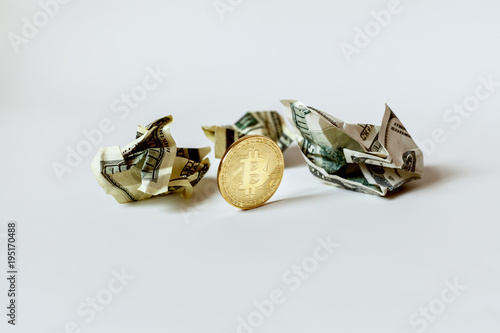 Bitcoin with crumpled bills.