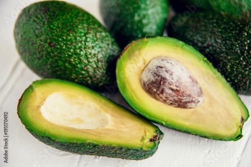 Group of organic fresh ripe and unripe avocados isolated on white background
