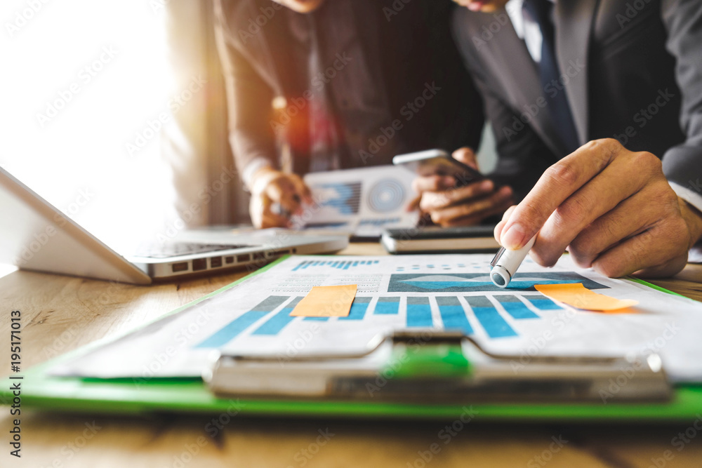 Team business meeting presentation. Hand businessman working   project in modern office.Laptop computer and tablet and smart phone on white desk in morning light
