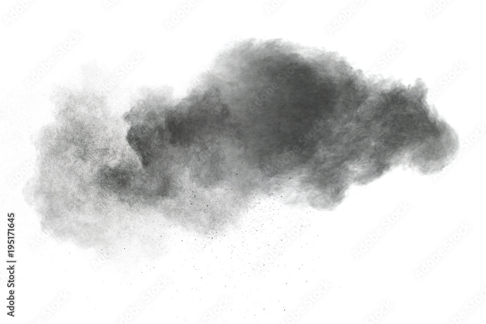 Black powder explosion against white background.The particles of charcoal splattered on white background. Closeup of black dust particles explode isolated on white background.