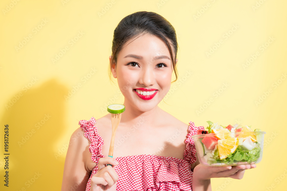 Asian beautiful woman summer outfit posing with fresh bowl of salad Asian beautiful woman summer outfit posing with fresh bowl of salad