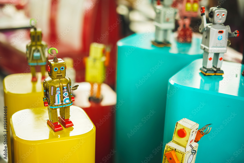 Group of vintage toys robot old color. Old vintage golden robot toy on a pedestal. Robotics and design of the past. Conceptual background of Technology.