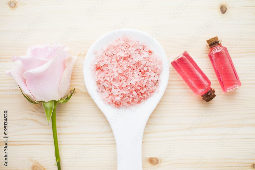 Spa and natural cosmetics concept. Set of sea salt, rose, natural clay ,shea oil, glass bottles and other spa treatment tools on the blue wooden background. Top view. Space for a text. Close up. Spa and natural cosmetics concept. Set of sea salt, rose, natural clay ,shea oil, glass bottles and other spa treatment tools on the blue wooden background. Top view. Space for a text. Close up.