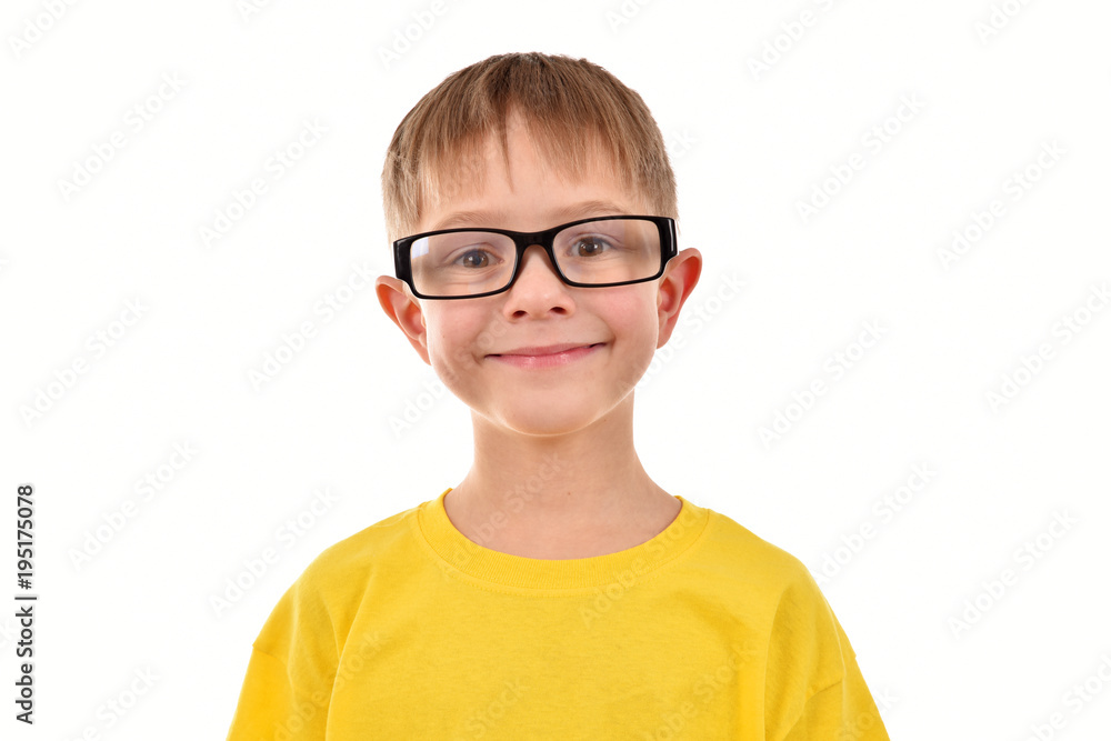 A boy in glasses. A yellow T-shirt. A child's portrait on a white background. A boy in glasses. A yellow T-shirt. A child's portrait on a white background.