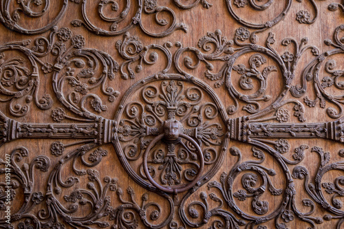 Old wooden door with a metallic pattern close-up. The cathedral Notre-Dame de Paris