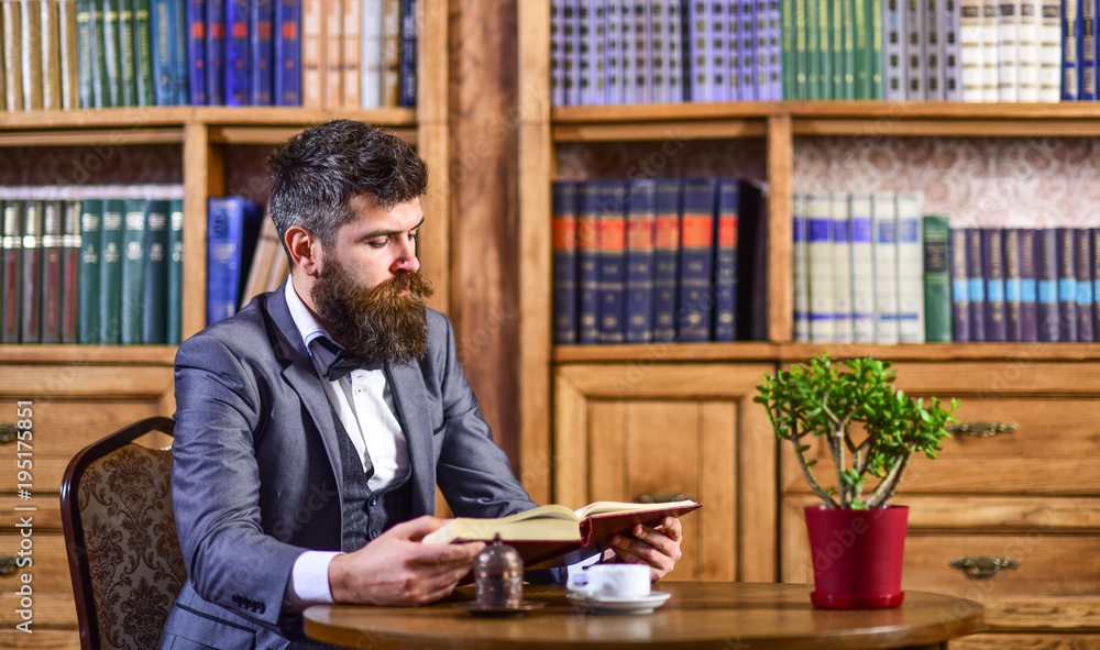 Bearded man in luxury suit in old library. Bearded man in luxury suit in old library.