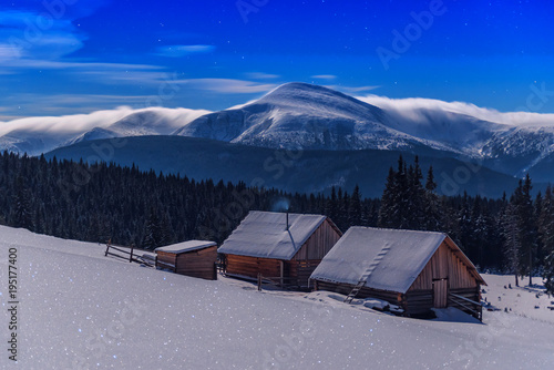 cabins under moonlight in winter