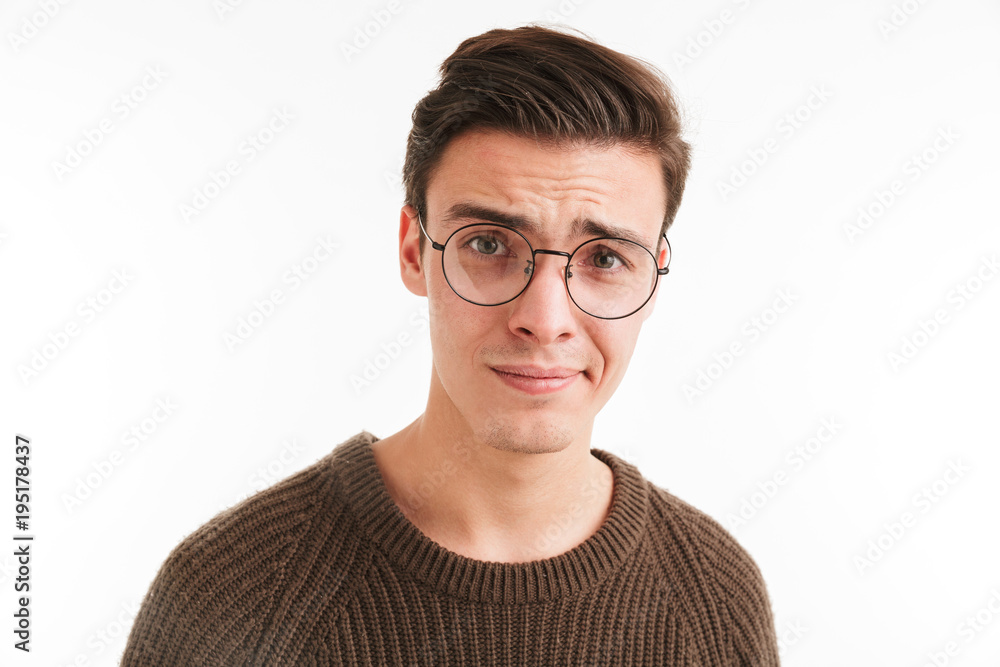 Close up portrait of a confused young man in sweater