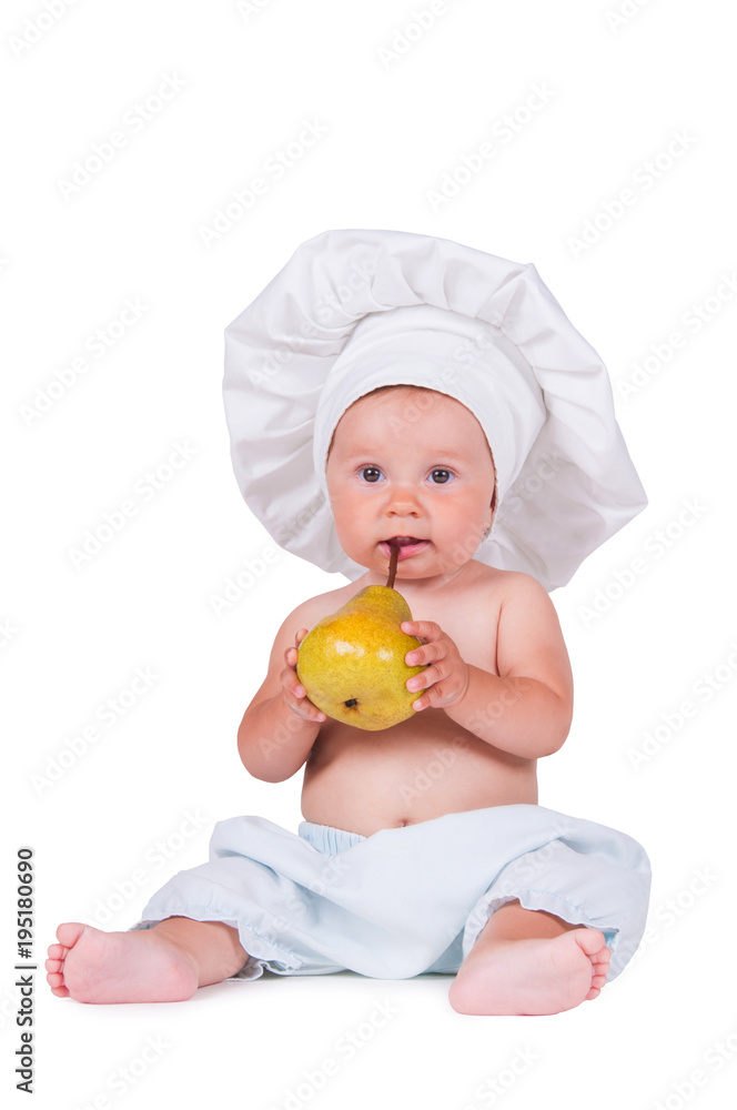 Cheerful little child with a pear in his hands in a chef suit on a white background. Cheerful little child with a pear in his hands in a chef suit on a white background.