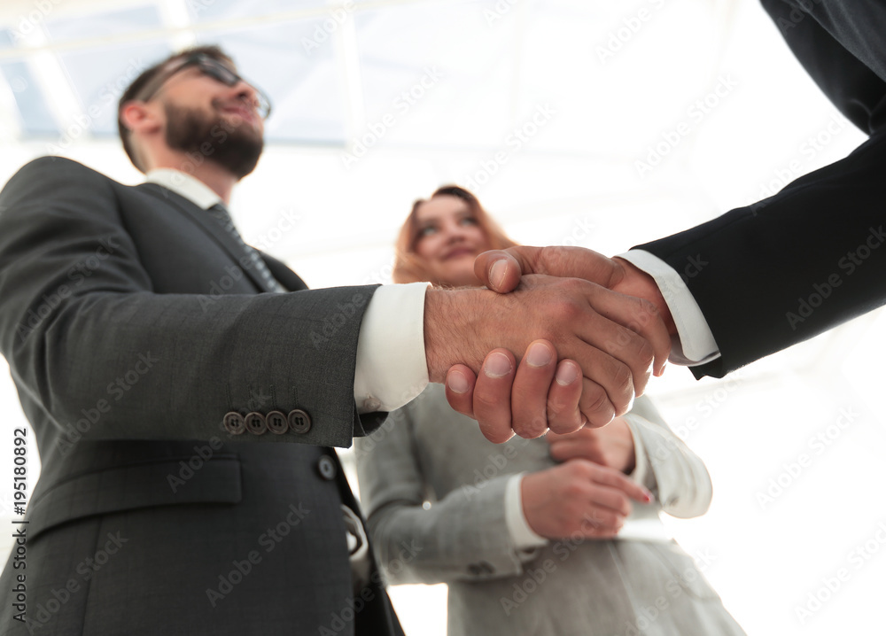 Photo of handshake of two happy businessmen