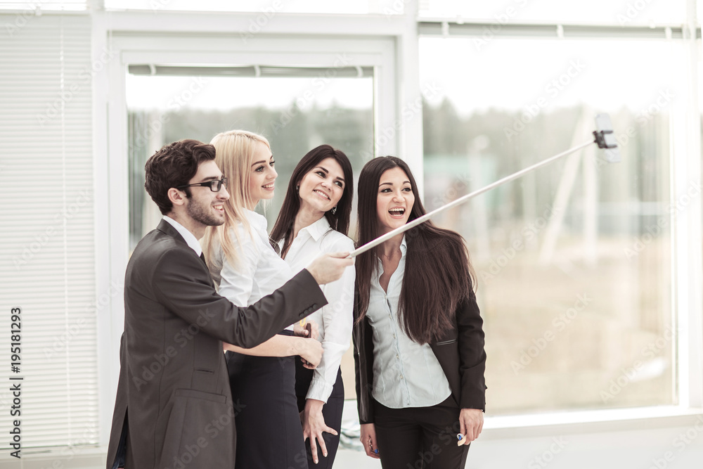 successful business team is doing a selfie in the lobby of the modern office successful business team is doing a selfie in the lobby of the modern office