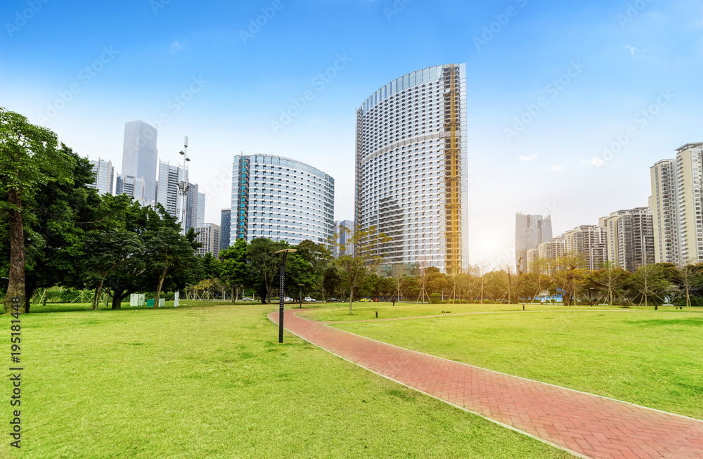 Grassy and flowery park and modern city architecture in Guangzhou, China