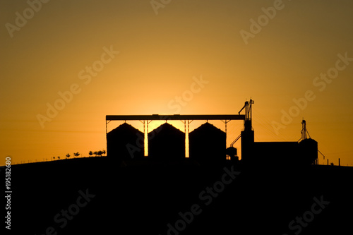 Silhouette of grain silos in the sunset. Curitibanos, Santa Catarina / Brazil