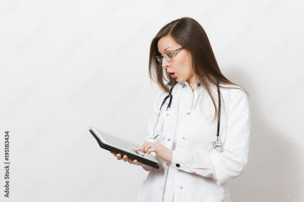 Astonished pretty young doctor woman with stethoscope, glasses isolated on white background. Female doctor in medical gown with tablet pc computer. Healthcare personnel, technology medicine concept. Astonished pretty young doctor woman with stethoscope, glasses isolated on white background. Female doctor in medical gown with tablet pc computer. Healthcare personnel, technology medicine concept.