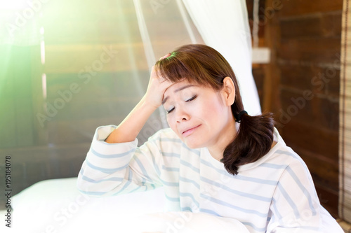 Asian Thai Woman Suffering From Depression Sitting On Bed And Crying