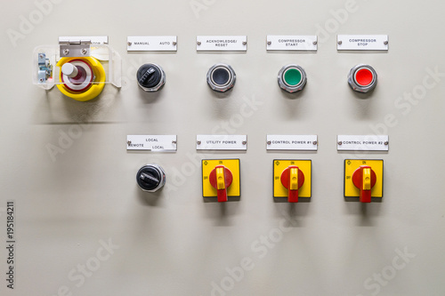 Electrical control panel contains switch buttons for operating industrial machine and factory equipment. Usually press green button to start, red button to stop and emergency stop button