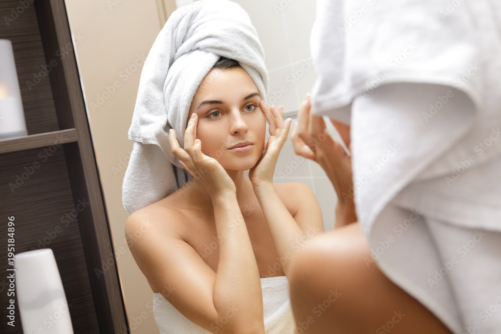 Beautiful woman is looking in the mirror Beautiful woman is looking in the mirror