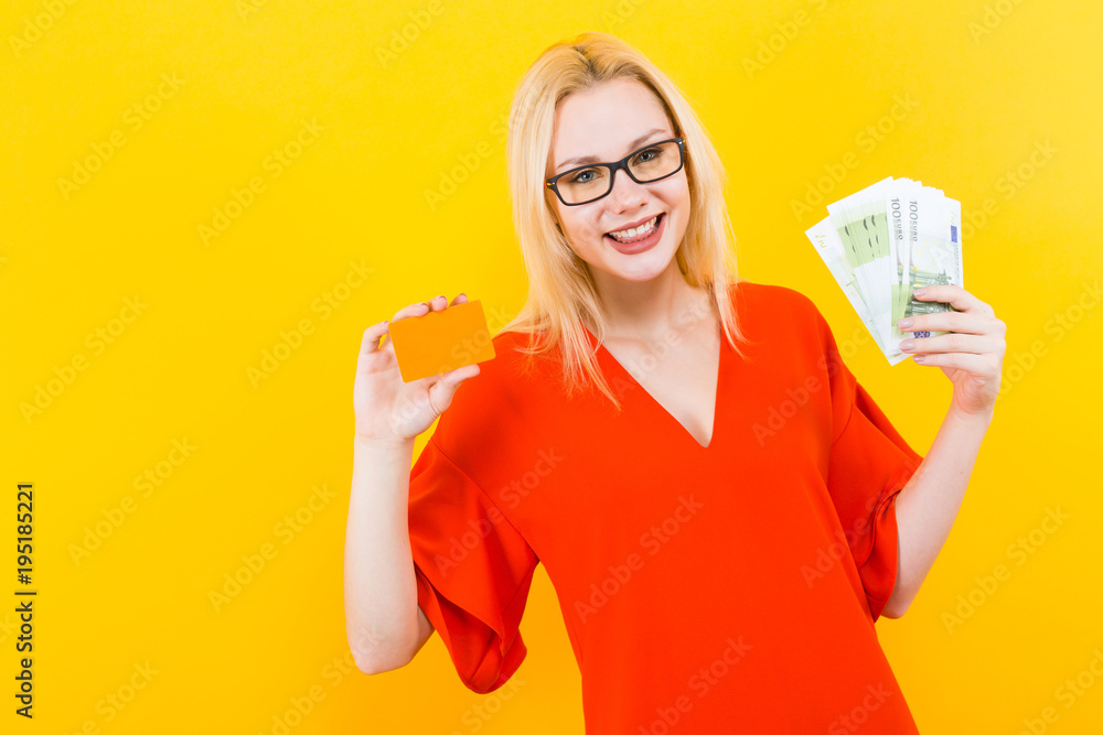 Blonde woman with credit card and cash Blonde woman with credit card and cash