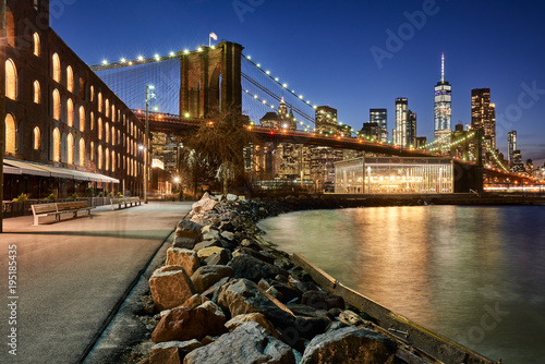 Fototapeta Naklejka Na Ścianę i Meble -  Brooklyn Bridge Park riverfront at twilight with view on the skyscrapers of Lower Manhattan and the Brooklyn Bridge. Brooklyn, Manhattan, New York City