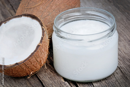Coconut oil in a jar on wood table